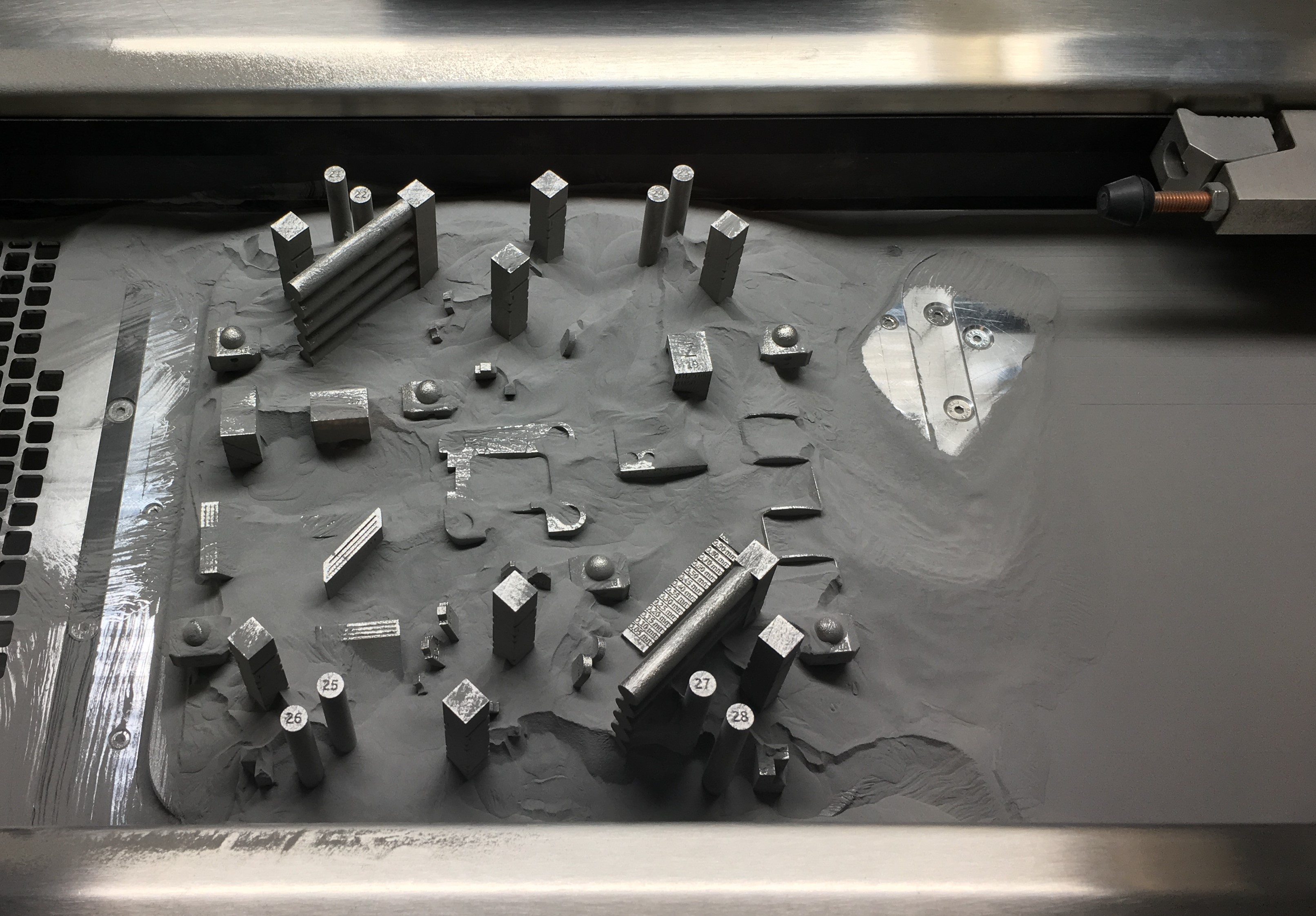Using the Concept Laser M2 Cusing Printer, researchers create steel test parts that will be evaluated to learn more about the characteristics of components produced with additive manufacturing technology. (Source: Edward Cyr, University of New Brunswick, St. John)