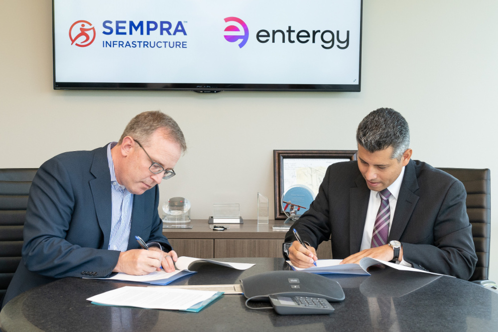 Hart Energy July 2022 - Sempra Entergy South Texas Renewable Energy Partnership - image of Martin Hupka and Eli Viamontes signing a MOU