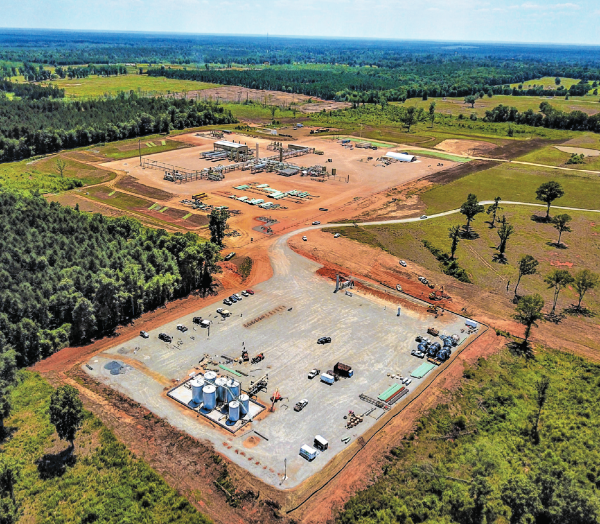 In the foreground, Indigo’s ROM CP compressor station for Cotton Valley operations in DeSoto Parish, La., next to the Longstreet processing plant built by partner Momentum Midstream, now owned by DTE Energy. (Source: Indigo Natural Resources)