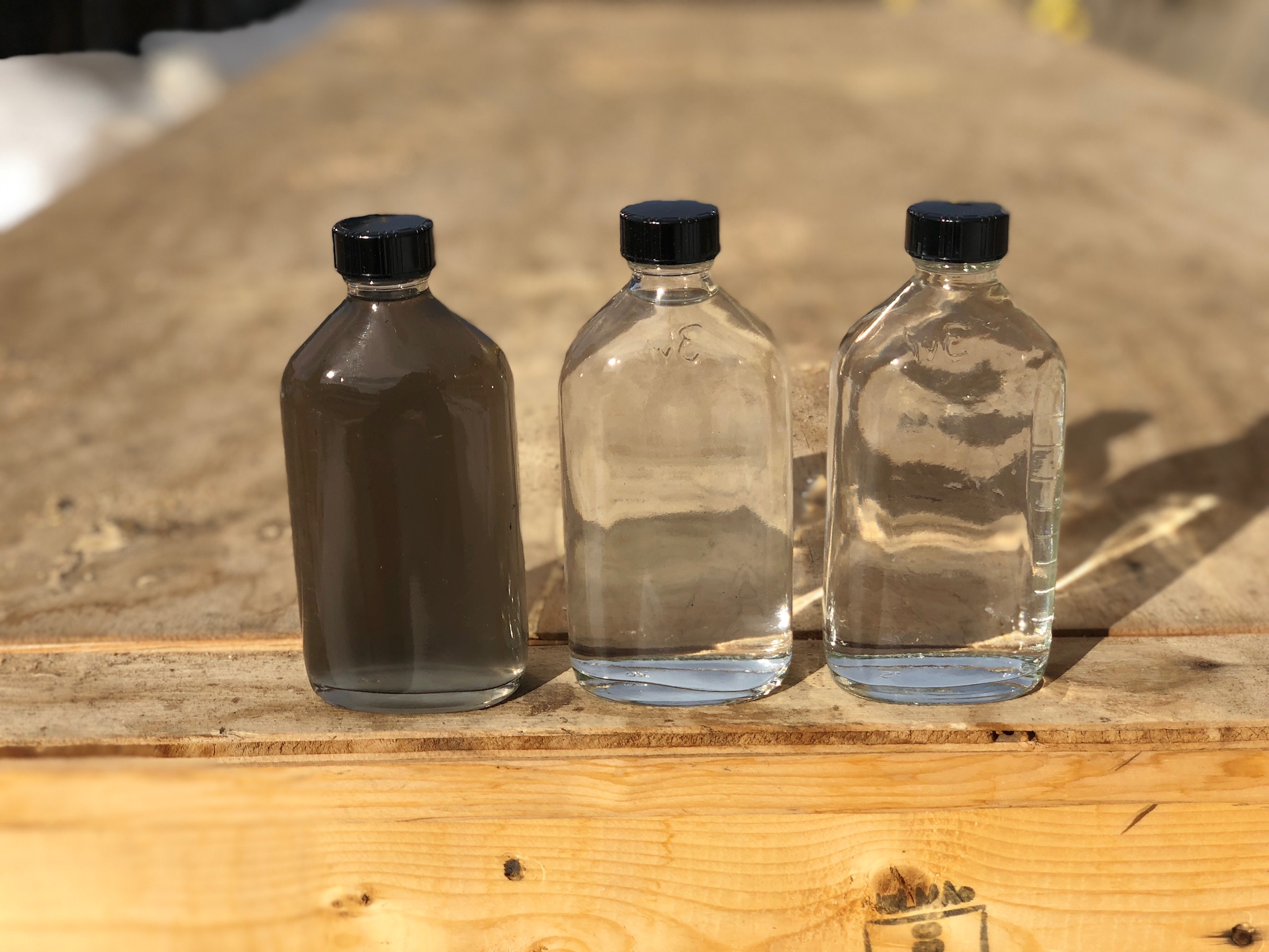 This blended produced and flowback water comparison shows water before (far left) and after treatments (middle and far right) with Monarch Separators’ H2O Floc and filtration. (Source: Monarch Separators)