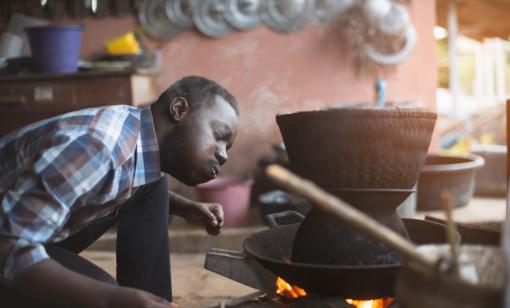 African man using fire for energy