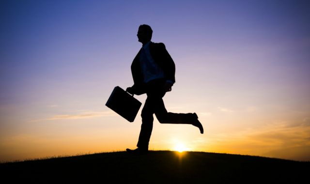 Silhouette of businessman with briefcase running