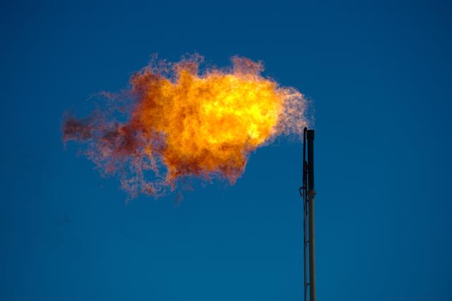 Excess natural gas is burned off at an oil well site. (Source: Sean Hannon/acritelyphoto/Shutterstock.com)