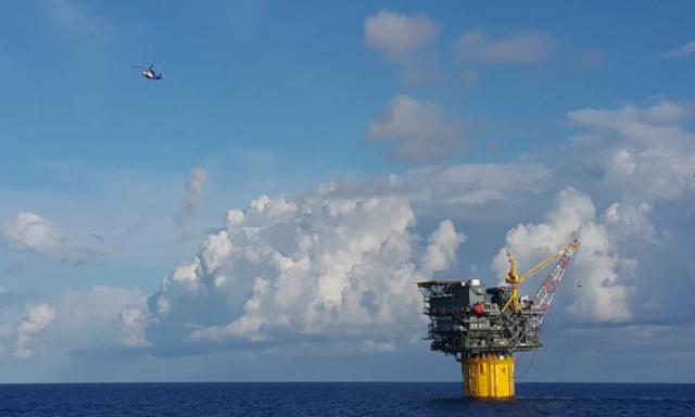 A helicopter departs a spar during crew change day at an oilfield in the Gulf of Mexico. (Source: Harris Hamdan/Shutterstock.com)