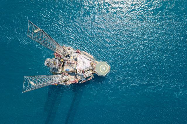 A jackup rig is towed to a location offshore. (Source: James Jones Jr./Shutterstock.com)