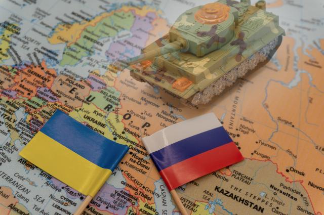Ukrainian and Russian flags placed on a map of Europe