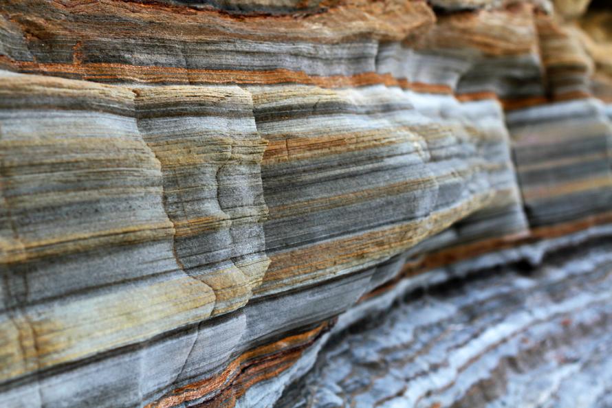 Layers of sedimentary sandstone rock are shown. (Source: SAPhotog/Shutterstock.com)