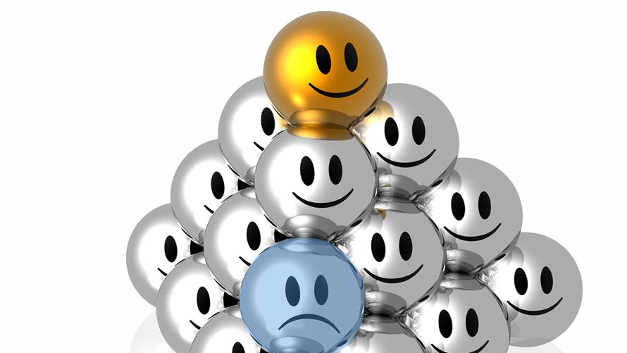 Image of a pyramid of smiley faces, with an unhappy face at the bottom of the stack.